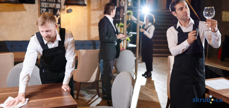 Professional food handlers preparing the restaurant before the arrival of client